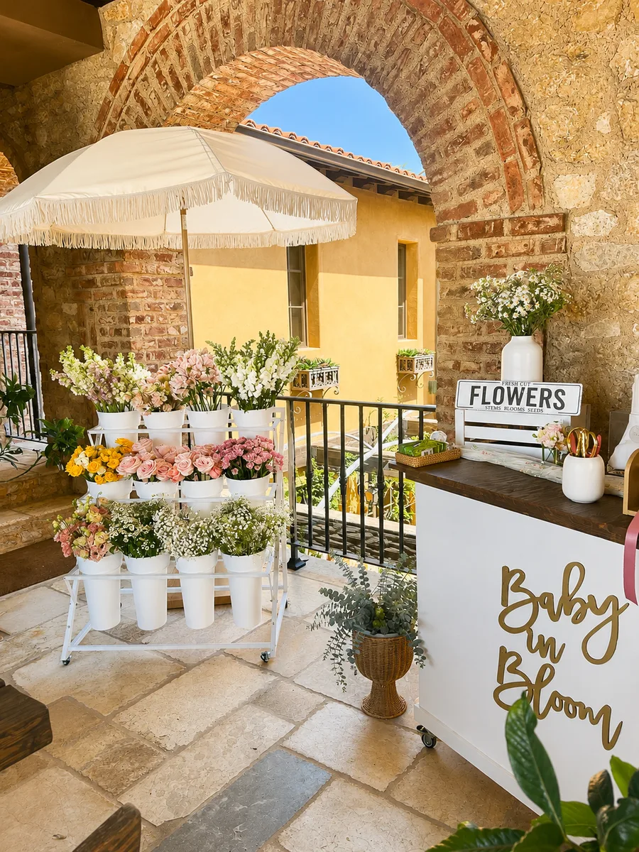 Baby shower bloom bar with Baby in Bloom sign under brick arch in Orange County