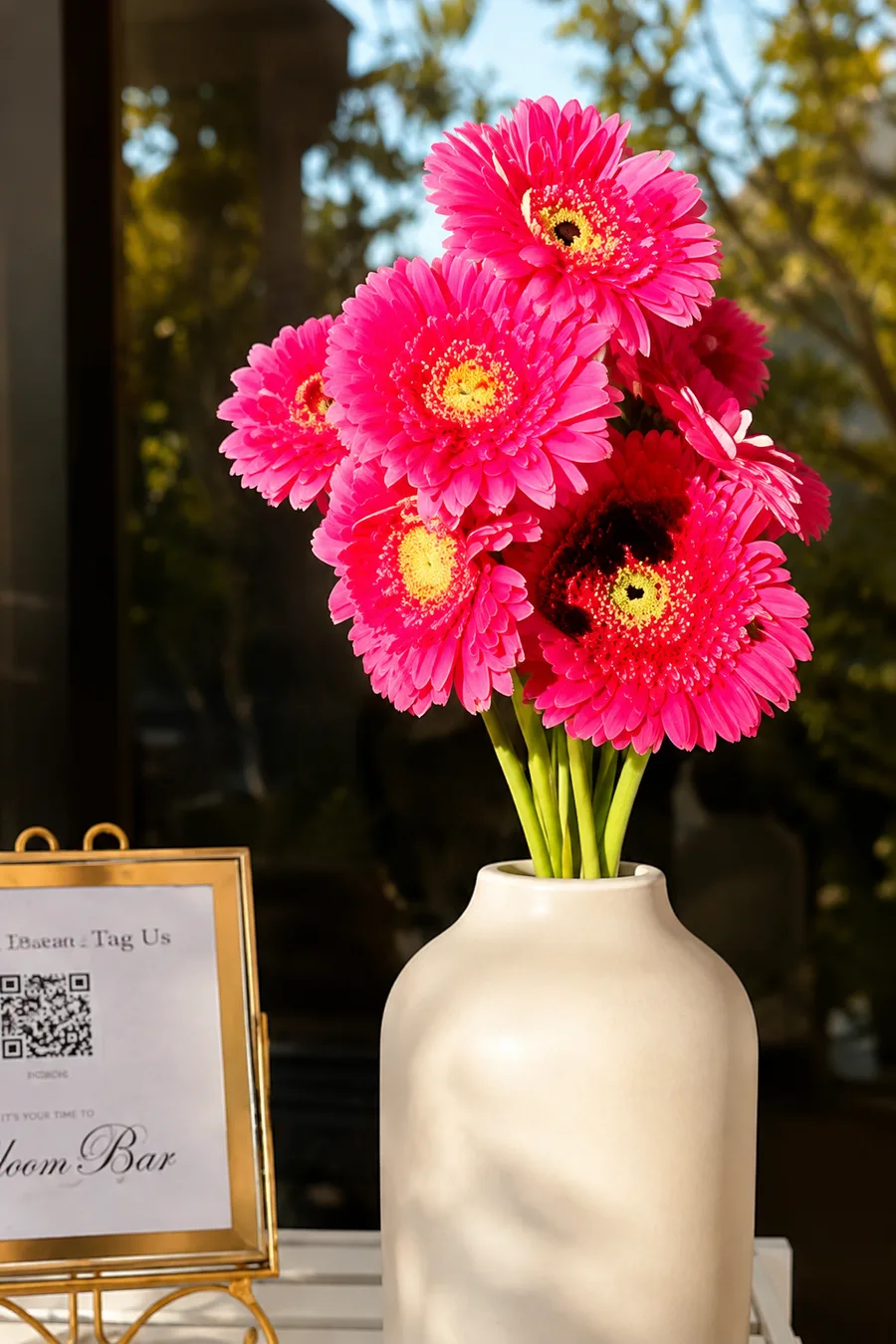 Hot pink gerbera daisies in a white vase at a bloom bar in Orange County