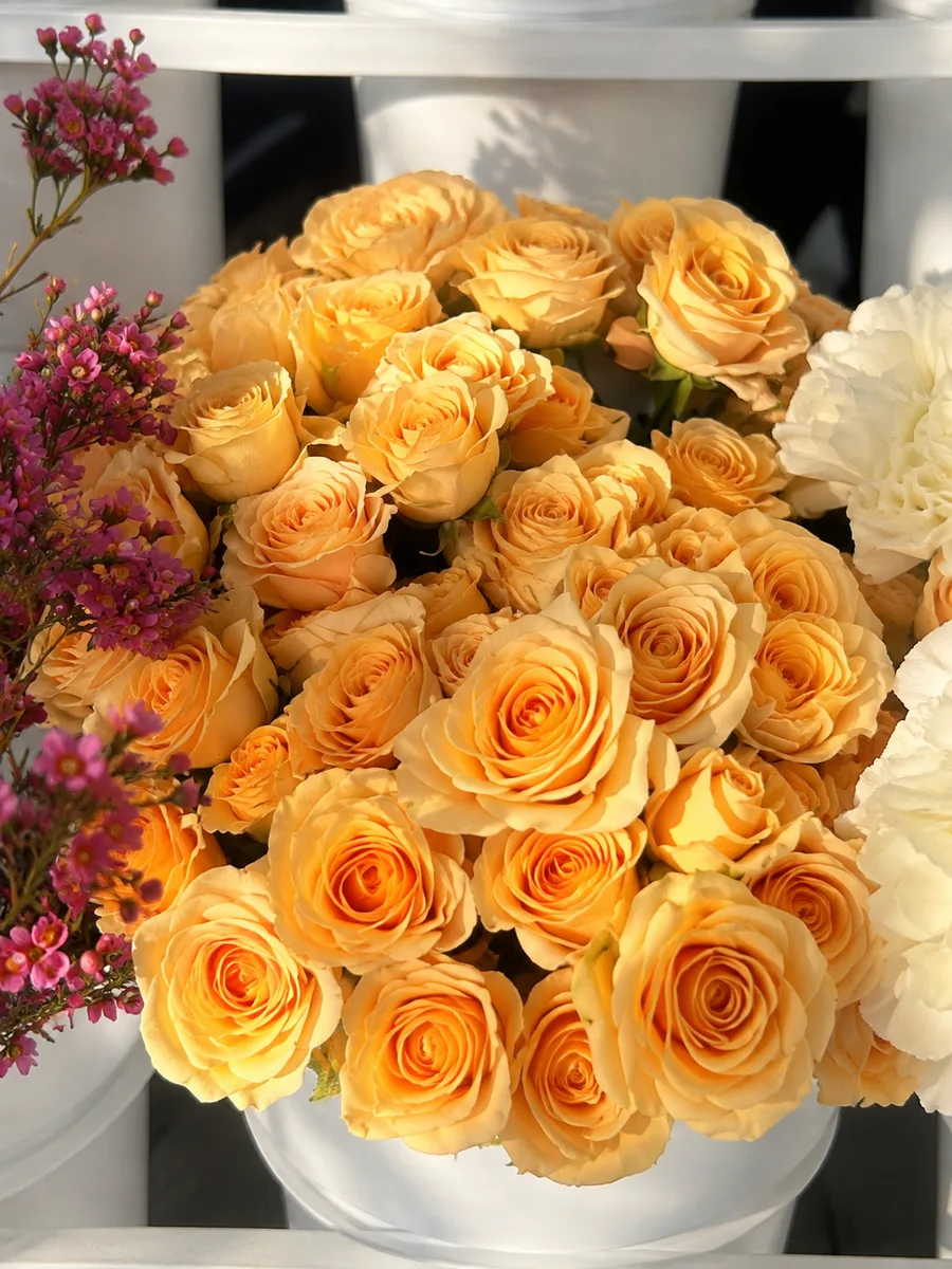 Peach spray roses and wax flowers at a bloom bar in Orange County