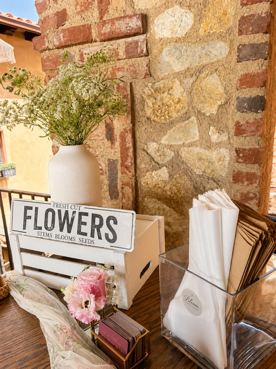 Bloom bar table setup with Fresh Cut Flowers sign and wrapping supplies in Orange County